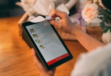 Swiggy Desk Eats: A Smarter Way to Eat At Work Person placing order on tablet using Swiggy Desk Eats for lunch at work with a receipt printing out.